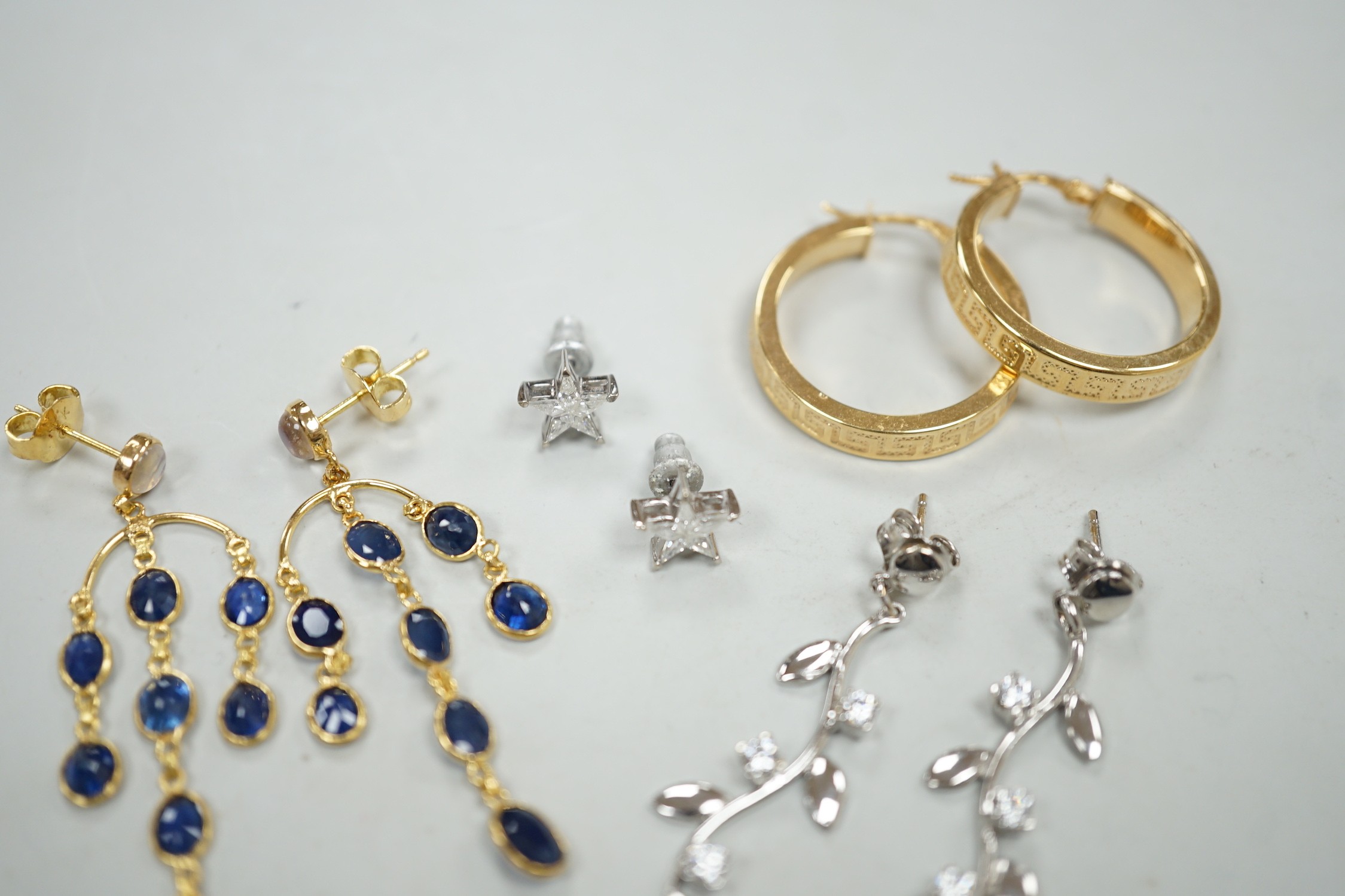 A modern pair of 18ct white gold and diamond cluster set star ear studs, 8mm, gross weight 1.1 grams, a similar pair of 14k, moonstone and sapphire cluster drop earrings, gross 3.5 grams and two pairs of 9ct earrings, gr